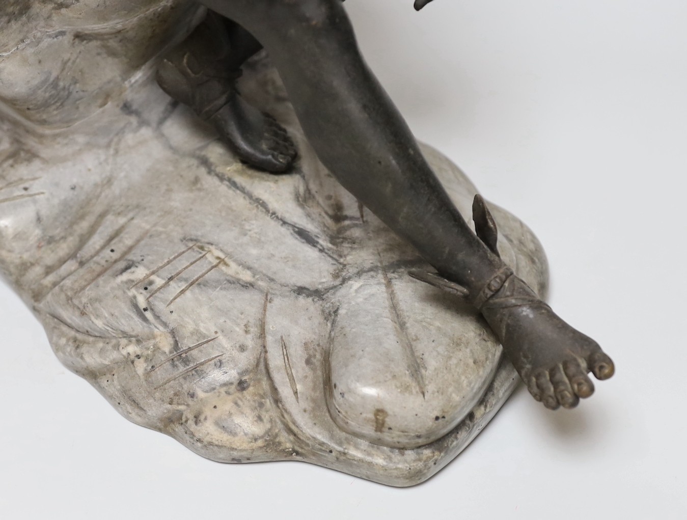After the Antique, a late 19th century bronze figure of Mercury, seated on a grey marble naturalistic rocky base, 41cm high